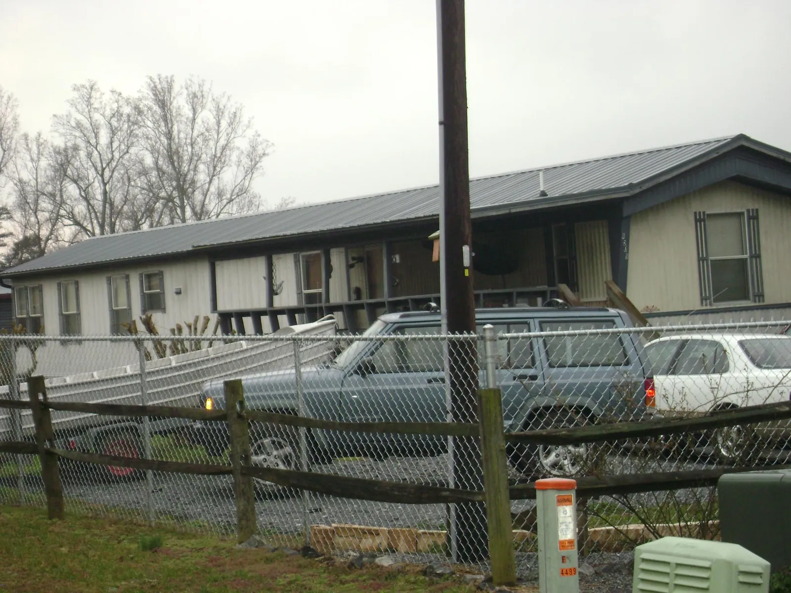 Dark metal roof on a long single story building behind a chain link fence in Dublin